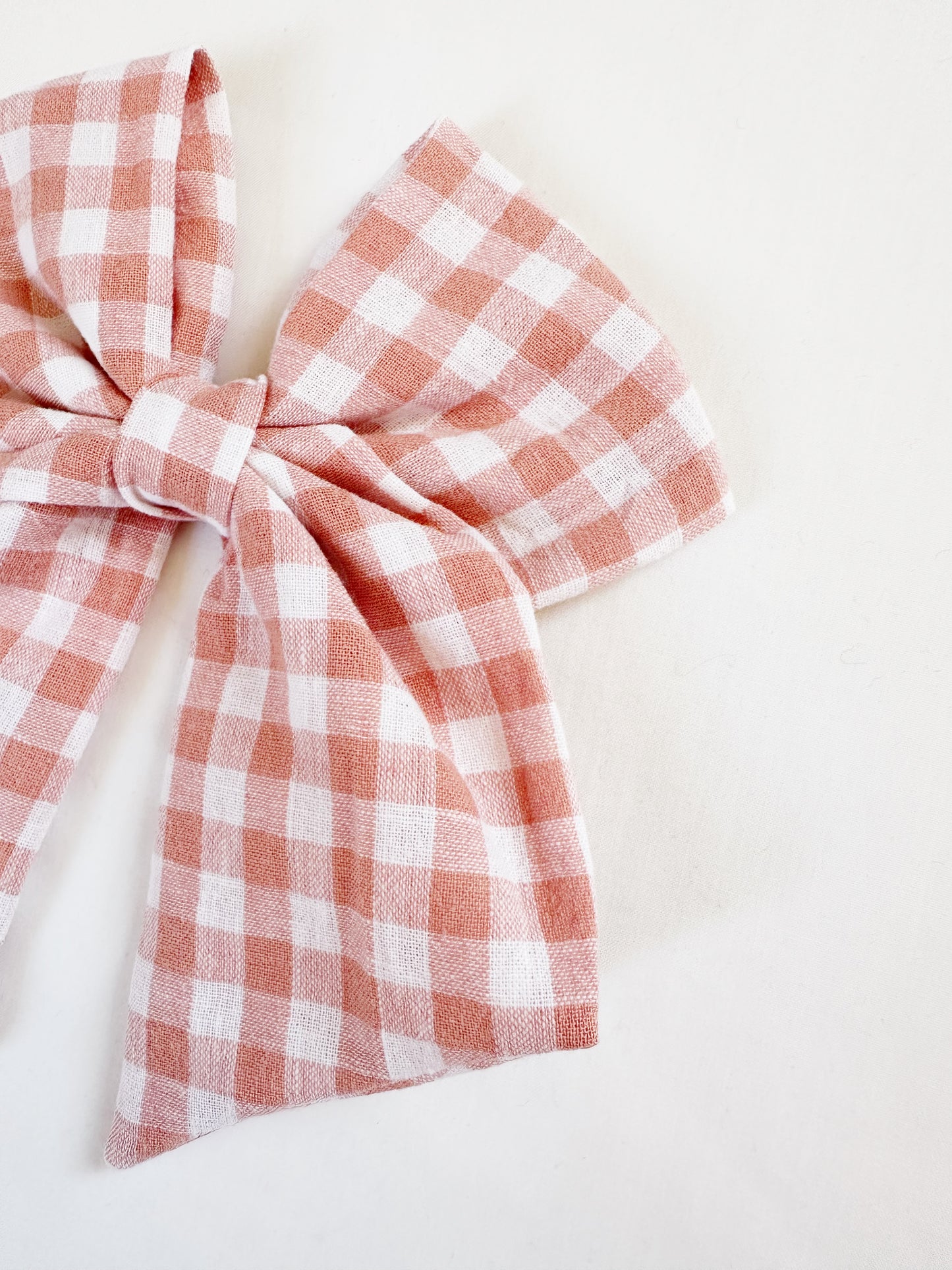 Beau hair bow in peachy pink gingham
