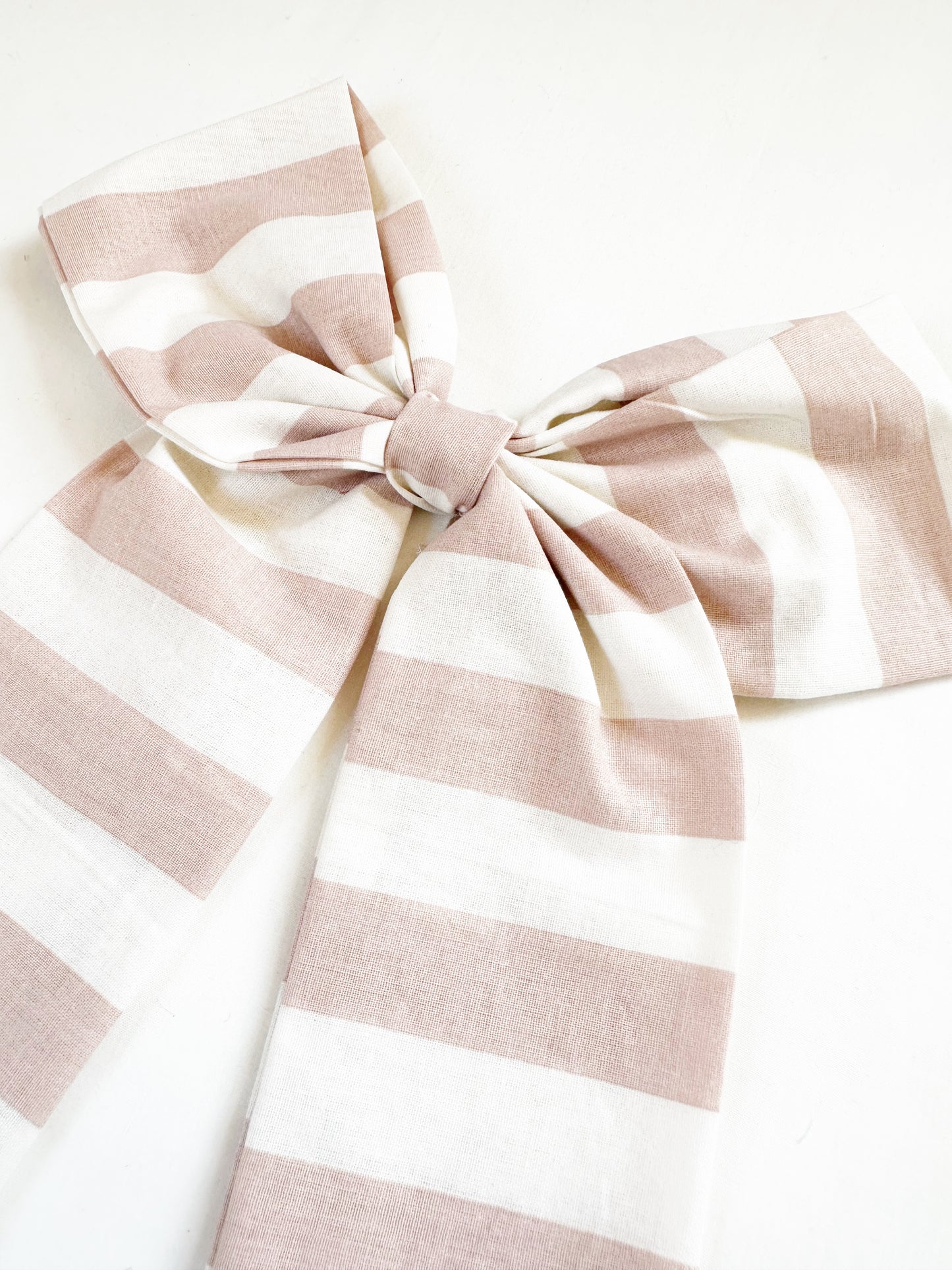 The Power Hair Bow in blush and white stripe