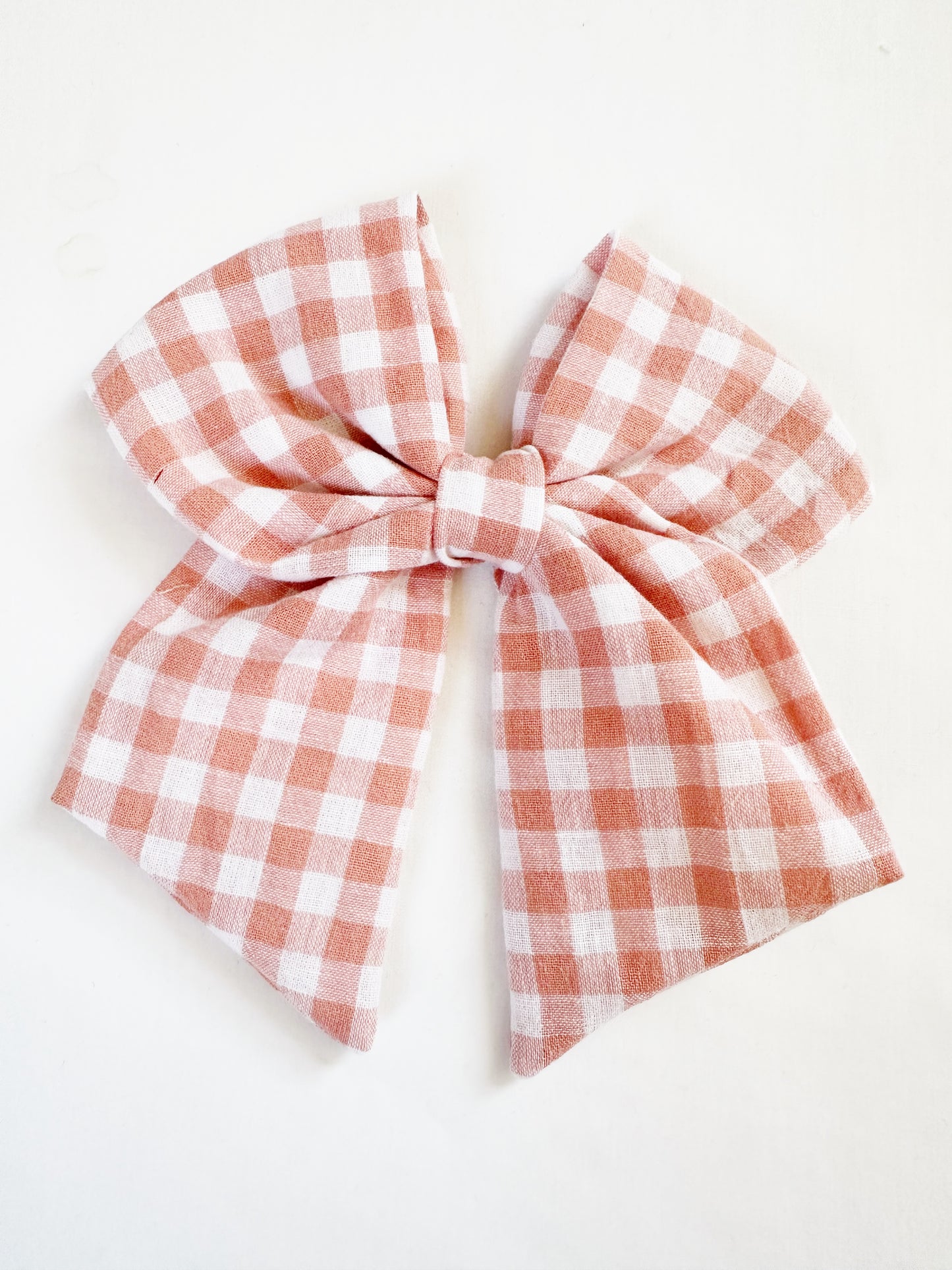 Beau hair bow in peachy pink gingham