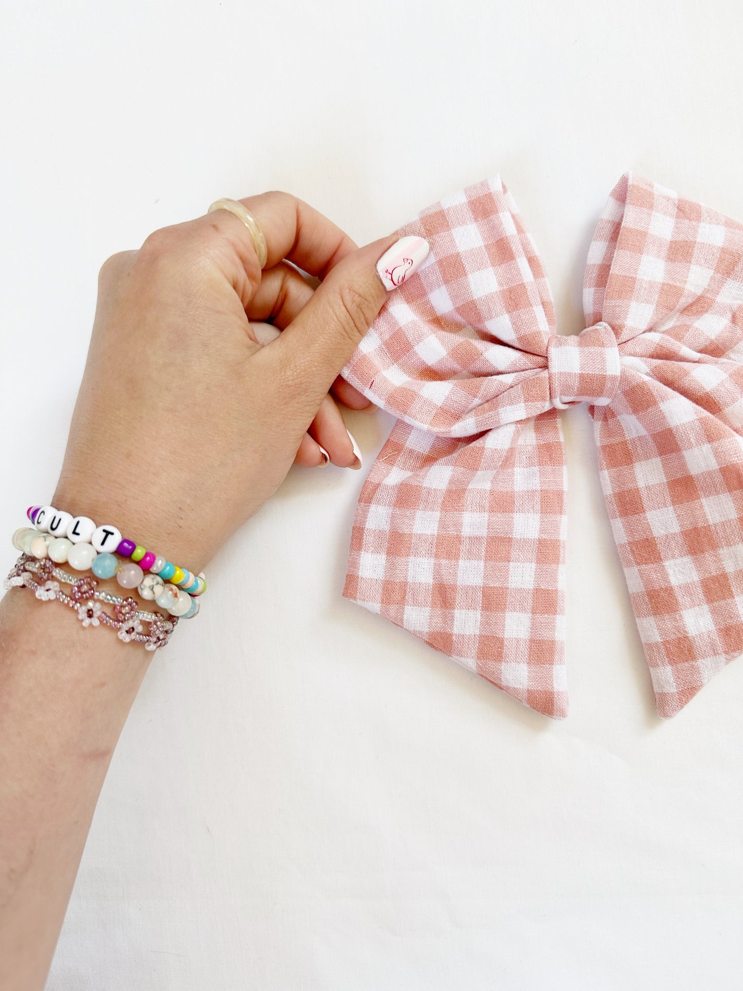 Beau hair bow in peachy pink gingham