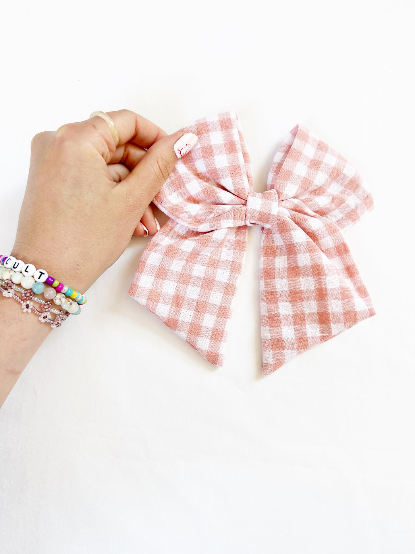 Beau hair bow in peachy pink gingham