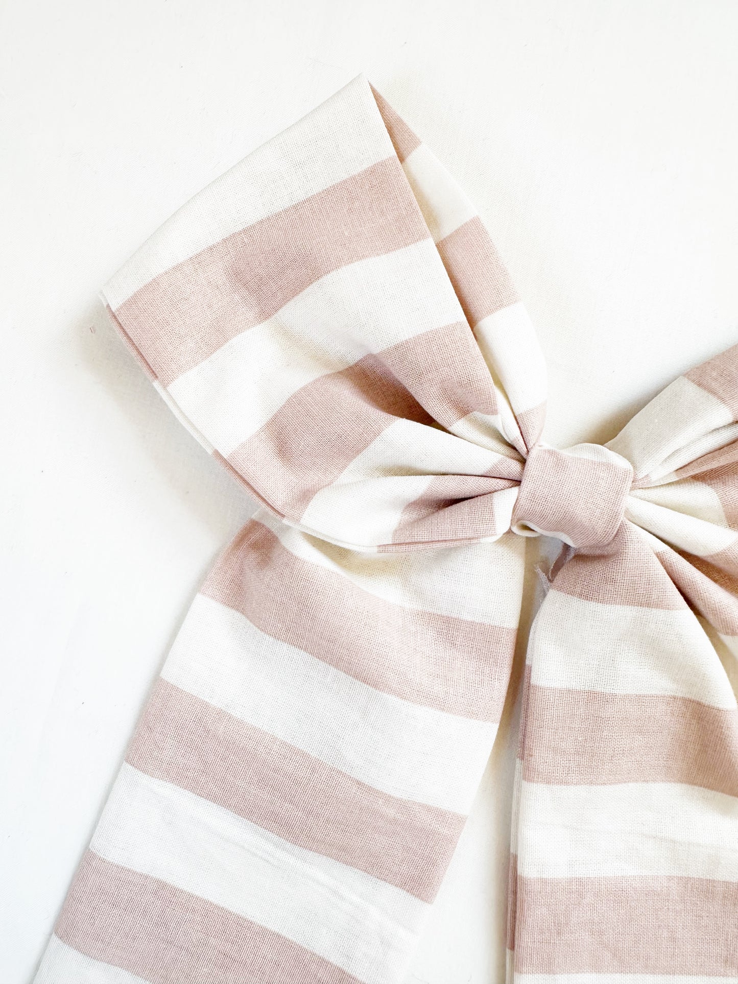 The Power Hair Bow in blush and white stripe