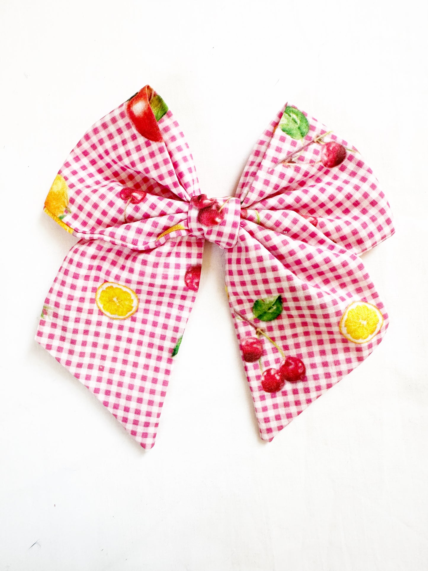 Beau hair bow in pink gingham with a fruit print