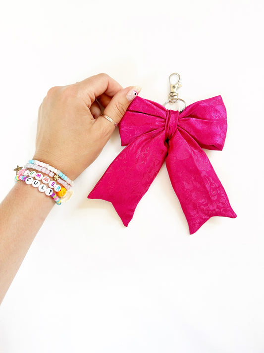 Puffy bow bag charm in silky hot pink