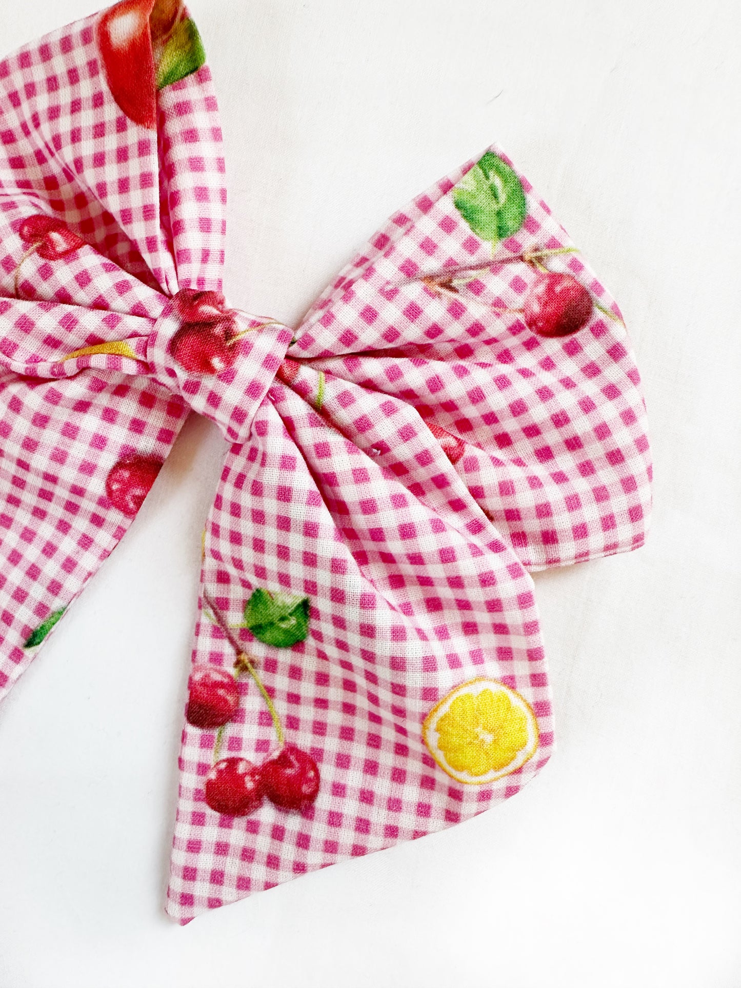 Beau hair bow in pink gingham with a fruit print