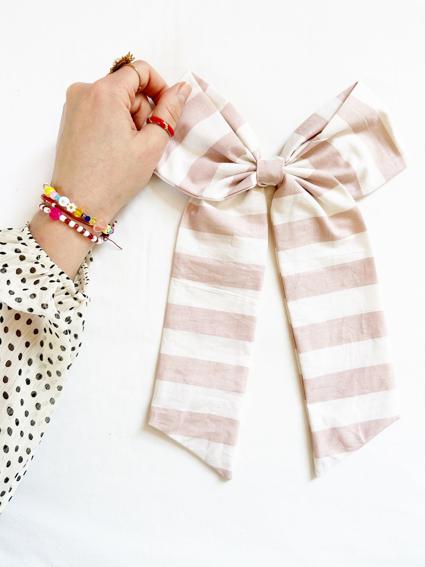 The Power Hair Bow in blush and white stripe