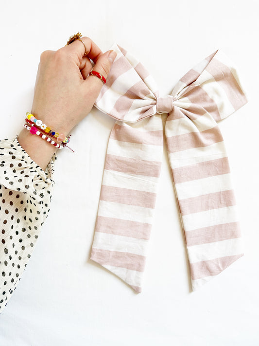 The Power Hair Bow in blush and white stripe