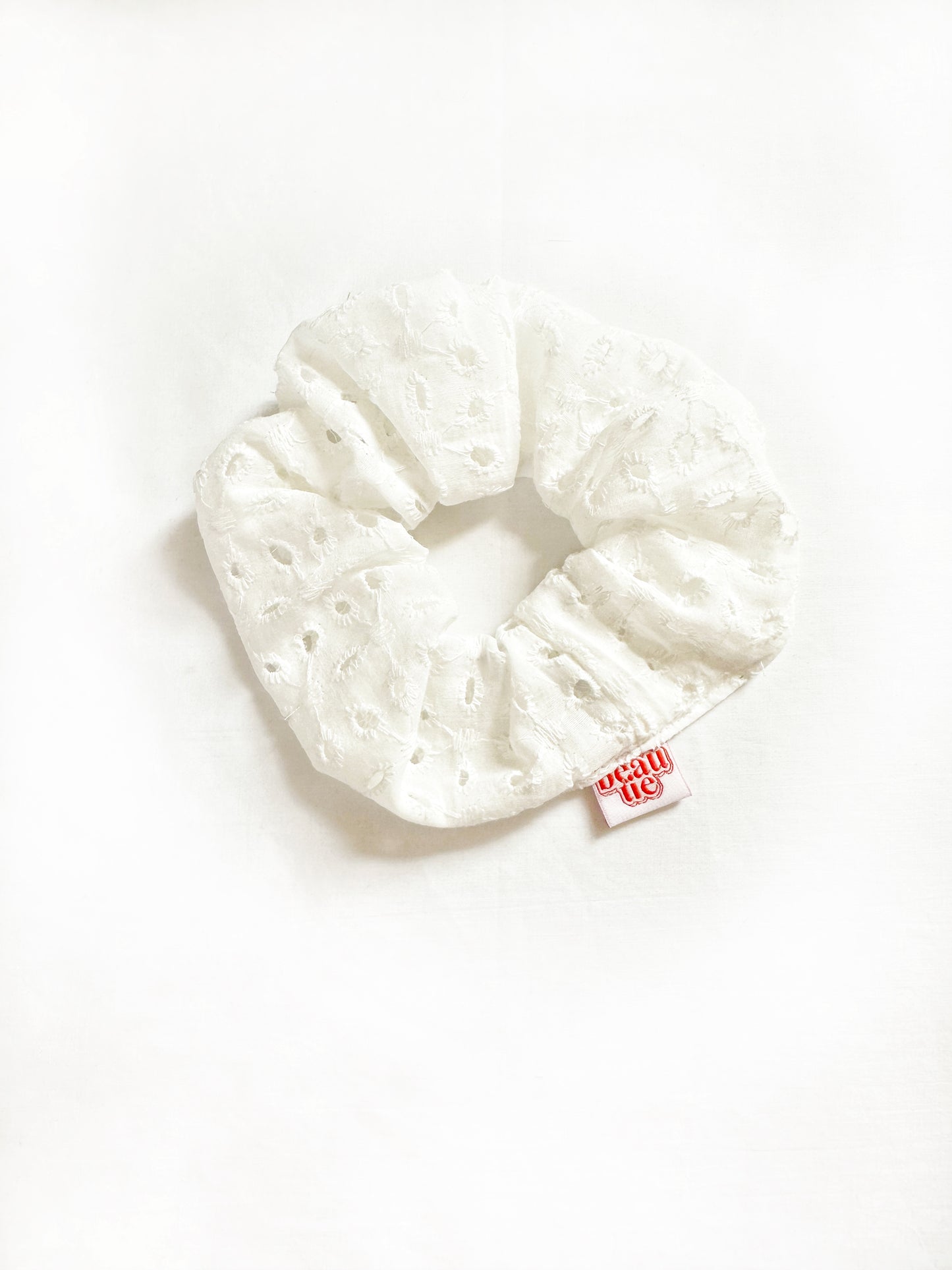 OG scrunchie in white broderie cotton
