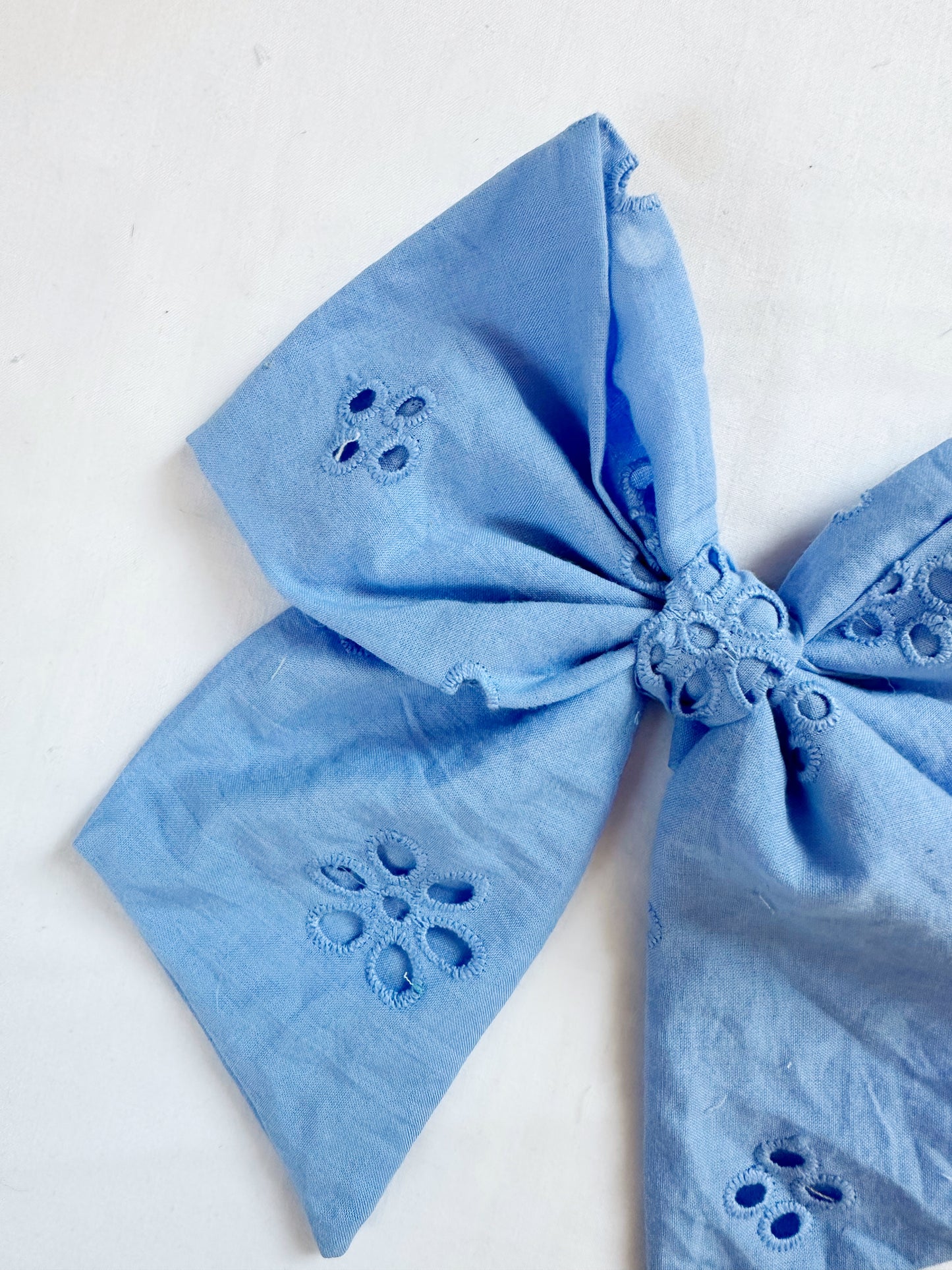 Beau hair bow in blue Broderie anglaise